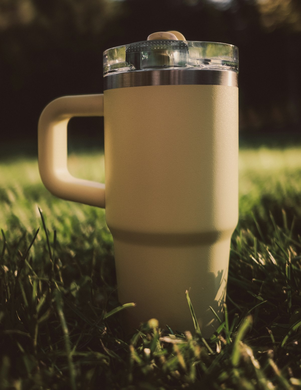 Yellow handled insulated mug outdoors; not the listed Stanley model